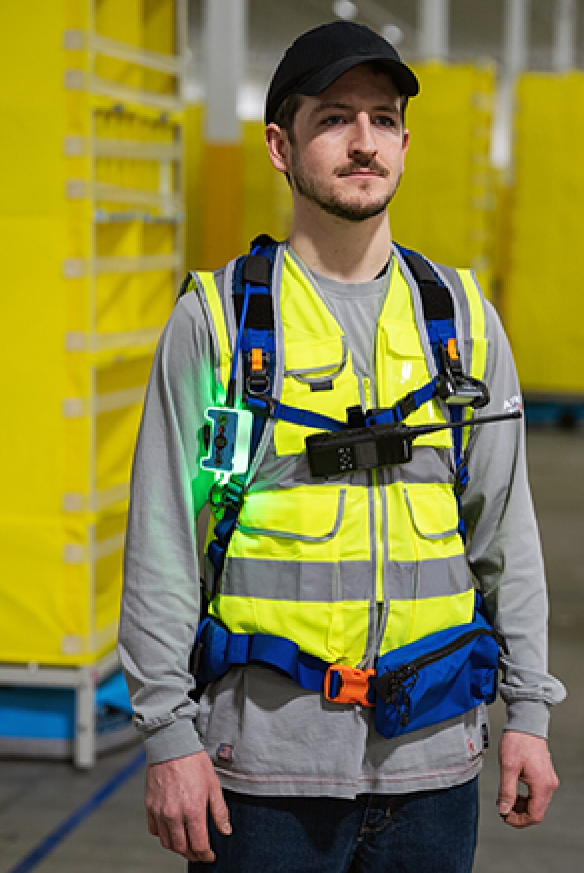 An Amazon employee is seen wearing a tech vest