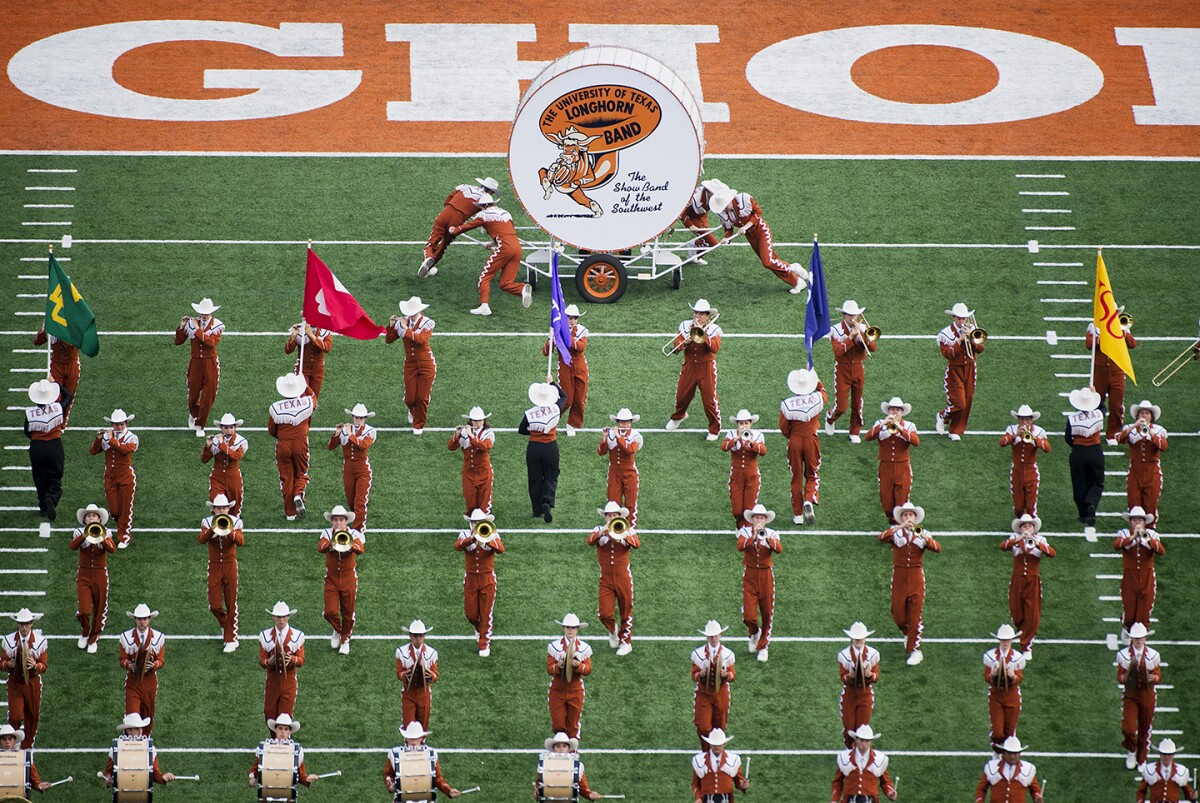 The UT Austin band is seen playing on the field