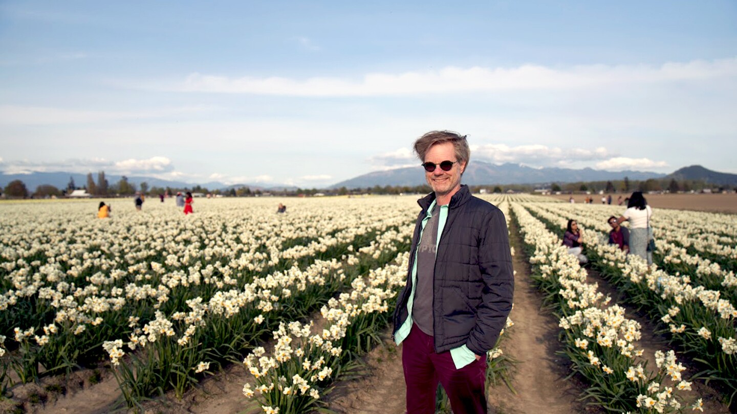 Rustan Leino, senior principal applied scientist, is seen standing in a lily field, he is smiling toward the camera