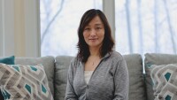 Ren Zhang, director of research science for personalization strategic initiatives, is seen sitting on a couch, posing for a photo