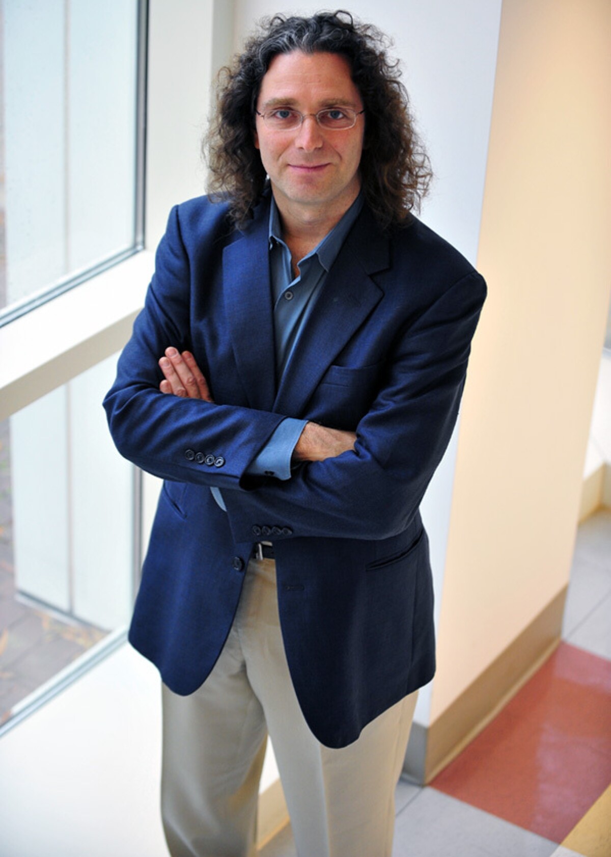 Philip Resnik, a professor at the University of Maryland in the Department of Linguistics and the Institute for Advanced Computer Studies, is seen standing in a hallway