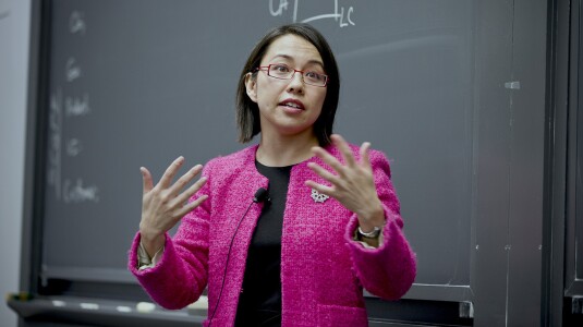 Pai-Ling Yin, senior manager of research science, is seen speaking to a classroom, there is a chalkboard behind her and she is gesturing with her hands.