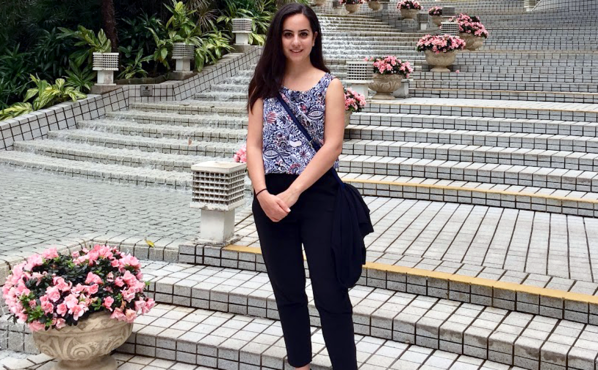 Nanneh Chehras, a senior economist at at Amazon, is seen standing on a stone staircase