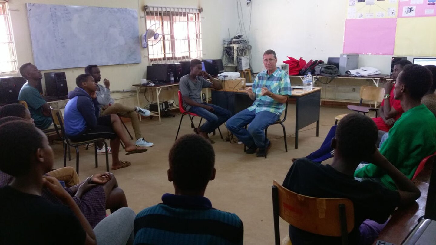 David Kosbie in a classroom with students in Rwanda 