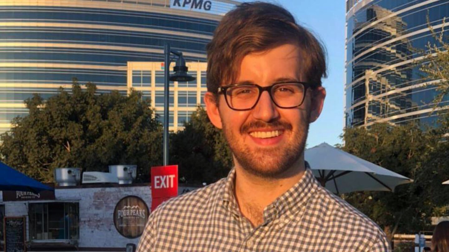 Image shows Amazon science intern Michael Saxon standing in front of two office buildings