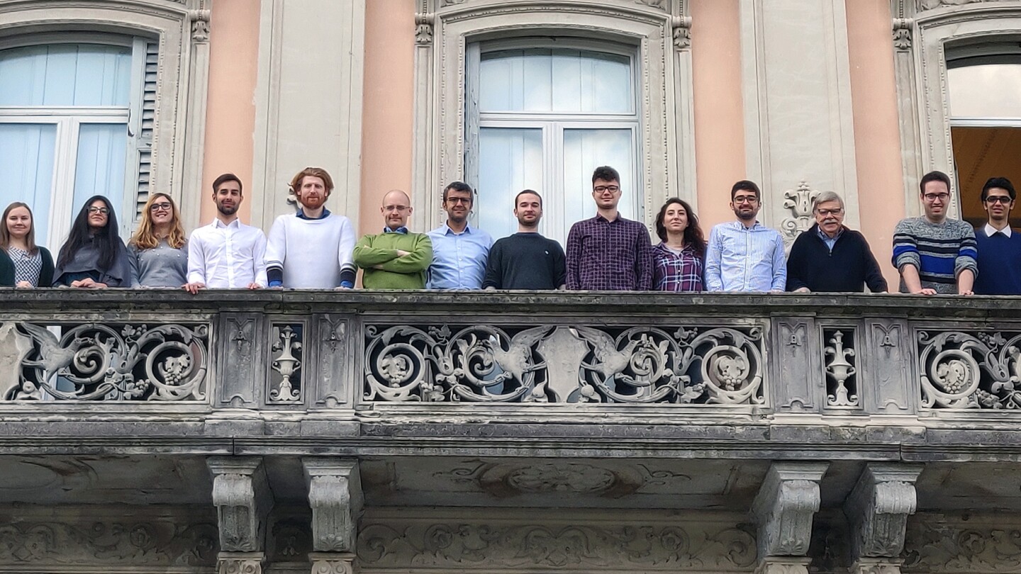 Politecnico di Milano professor Stefano Ceri, third from right, and some of his team are pictured here standing on a stone balcony