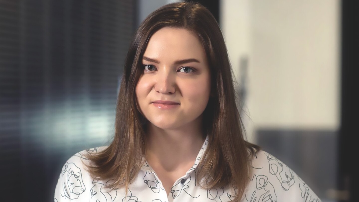 Violetta Shevchenko, an applied scientist, is seen looking into the camera while standing