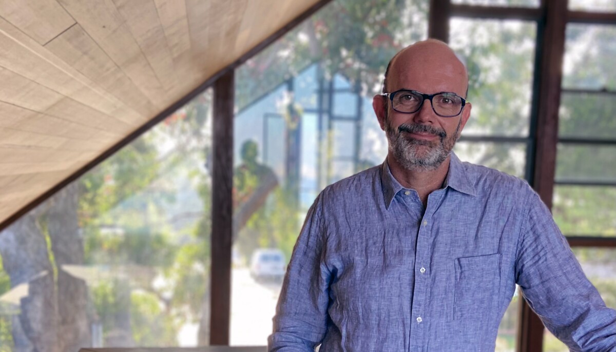 Alex Guazzelli, director of machine learning in Amazon’s Customer Trust and Partner Support unit, stands in front of a window