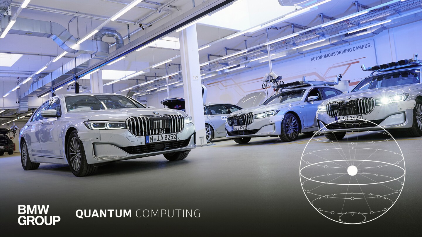 This image shows several white BMW vehicles parked in a facility with the words autonomous driving campus printed on a wall in the back. The BMW Group name and logo appear on the bottom along with the words quantum computing.