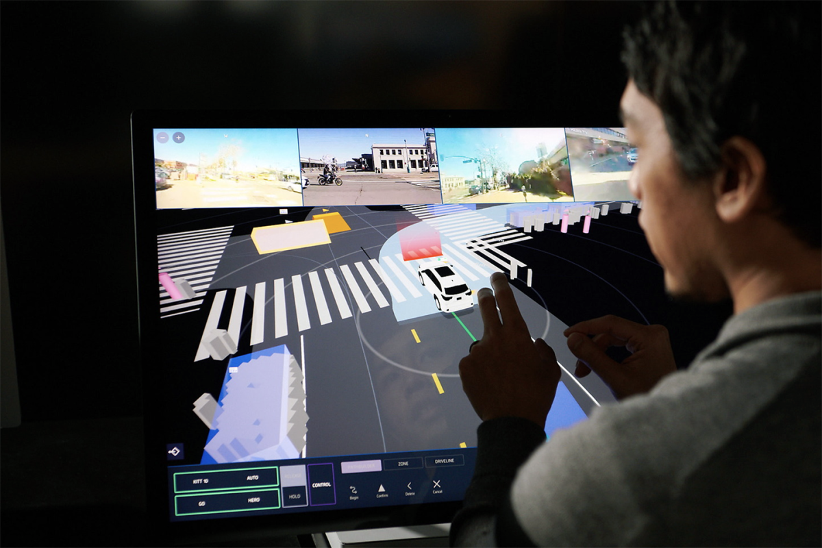 A Zoox TeleGuidance tactician providing remote guidance to a vehicle from the Zoox HQ