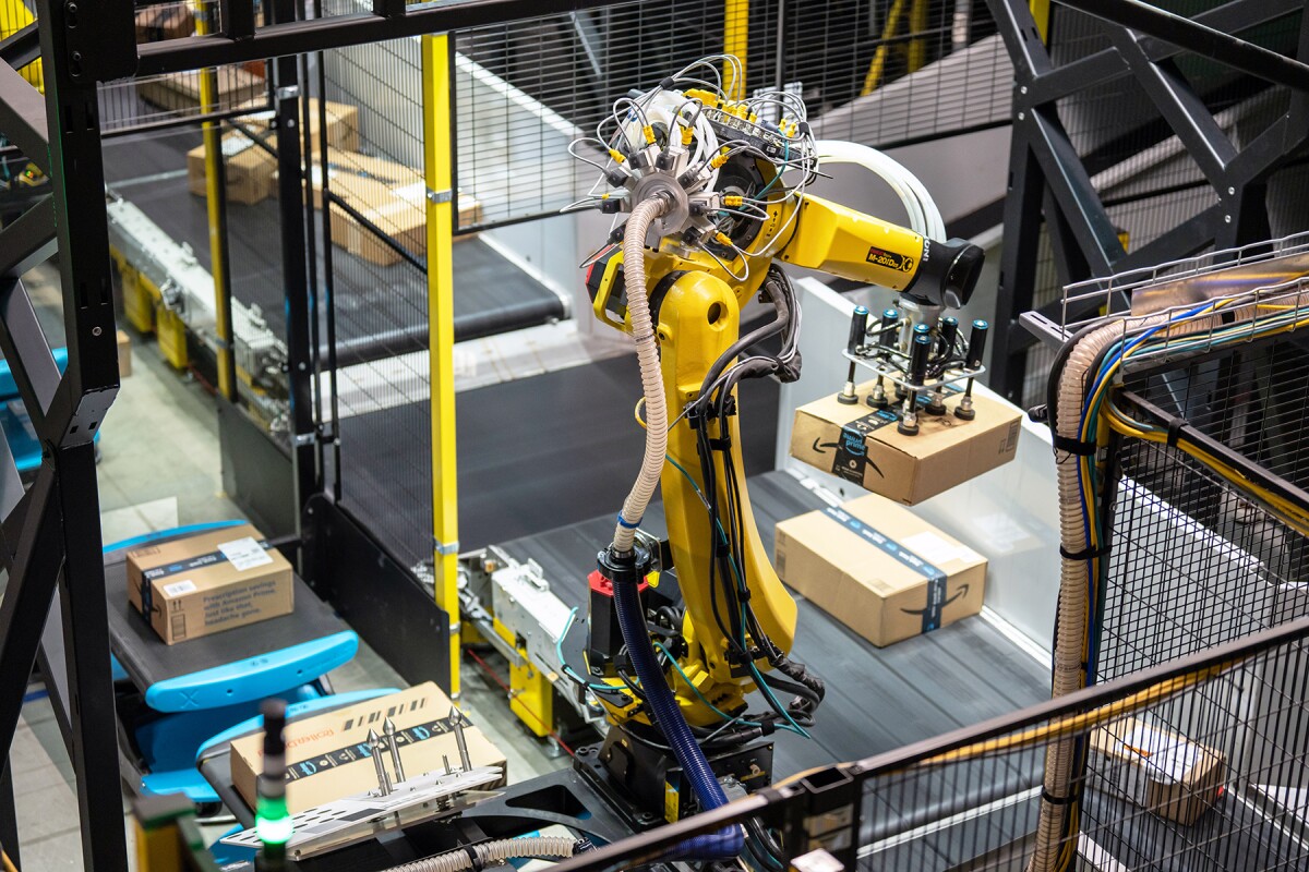 Amazon's Robin robot arm is seen lifting packages