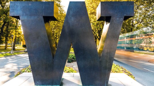 Photo shows the University of Washington north campus W in the sunshine with fall color